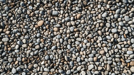 Smooth pebbles on serene beach shoreline texture