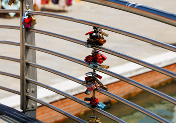 Love locks on metal railings by waterfront