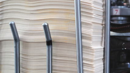 Elements of corton boxes are collected in stack. Conveyor line for production of boxes. Machine...