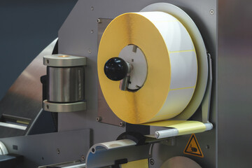 Fragment of the conveyor of sticking labeling machine. Abstract industrial background.