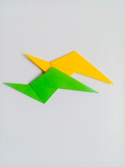 Green and yellow lightning origami isolated on white background.