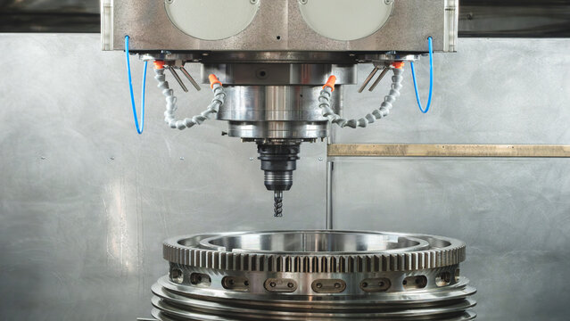 Large metal turbine on table of industrial metalworking programmable CNC machine, industrial machine concept background