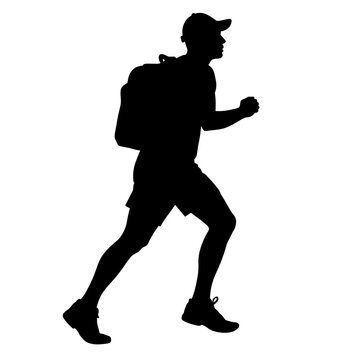 Silhouette of a hiker walking with a backpack outdoors  