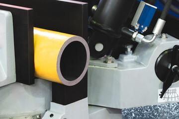 automatic circular saw cutting large metal part with round cross-section, industrial concept...