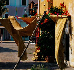 Sunny courtyard with clothesline and vibrant buildings