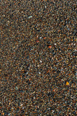 Top view of smooth pebbles covering the beach. Natural stone texture perfect for backgrounds, design projects, travel, and eco friendly themes.