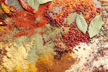 Different aromatic spices on grey table, top view