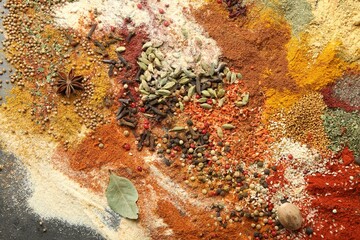 Different aromatic spices on grey table, top view
