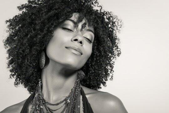 Elegant black and white portrait of a woman with curly hair. Perfect for fashion, beauty, and haircare marketing. Ideal for websites, magazines, and social media.