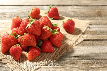 Fresh ripe strawberries on wooden table, closeup