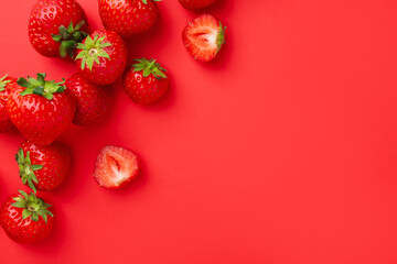 Fresh ripe strawberries on red background, flat lay. Space for text