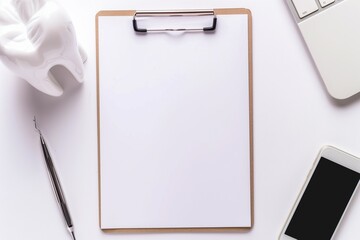 Blank dental chart clipboard with pen and tooth model on table, clean white background, flat lay mockup for dentist office.