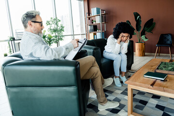 Professional Therapist Consults a Concerned Client During a Counseling Session in a Modern Office...