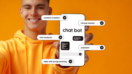 Young man showcasing a chatbot interface on a smartphone against a bright orange background