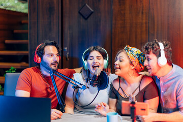 Young radio hosts recording a podcast at home studio