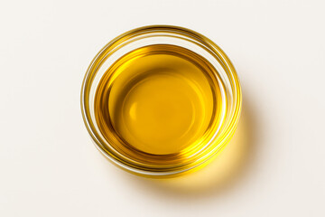 Glass Bowl of Golden Olive Oil on Neutral Background