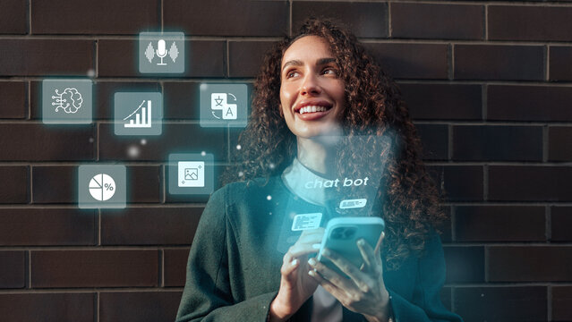 Young woman interacting with a smartphone while engaging with chatbot features against a dark brick background