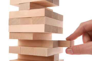 Lviv, Ukraine - December 05, 2023: Woman playing Jenga on white background, closeup