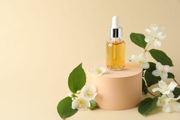 Cosmetic product and jasmine flowers on beige background. Space for text