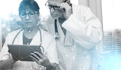 Two doctors discussing about medical report on tablet; light effect