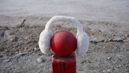 pillar wearing earmuffs in winter