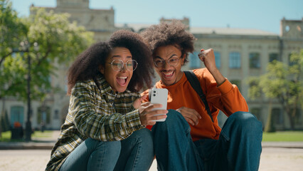 Two happy African American students multiracial friends African American woman girl female with boy...