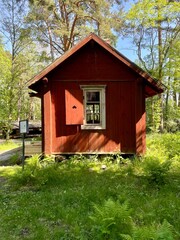 An old red plank wooden cottage. Finland