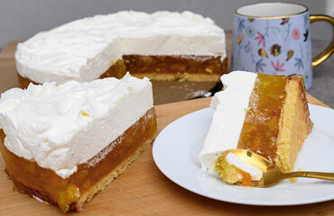 Eating sweet cake and drinking coffee, a piece of peach cake on a plate