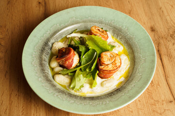 Gnocchi with creamy sauce and bacon-wrapped chicken