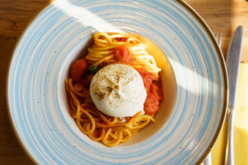 Spaghetti with tomato sauce and burrata cheese