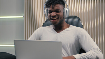 African American ethnic cyber man in white futurism studio indoors business male user gamer hacker...