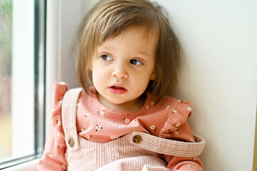 Baby girl near the window