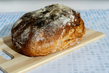 Rustic homemade bread on wooden cutting board