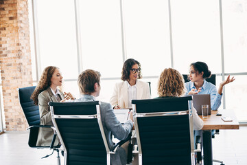 Group of business professionals collaborating in modern office space, discussing projects and ideas...