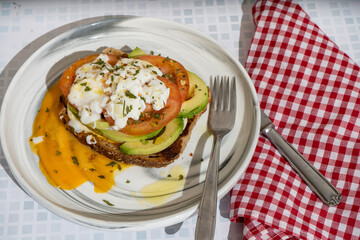 Delicious guacamole toast with fresh tomato and avocado