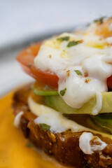 Delicious guacamole toast with melted cheese topping