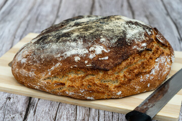 Rustic homemade bread on wooden cutting board