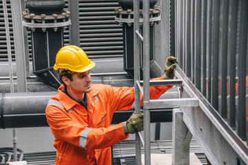 Professional worker servicing HVAC building cooling tower, Industry air conditioner service