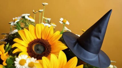 Festive autumn arrangement features vibrant sunflowers, delicate daisies, witch hats, and adorable witch figurines on an open book. - Powered by Adobe