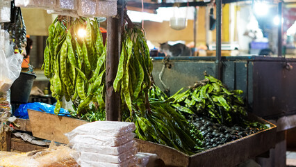 Fresh Satay Beans Hanging and Displayed at a Vibrant Market Stall