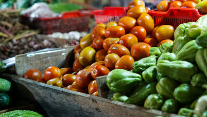 Vibrant Tomatoes and Chayotes at a Market Stall