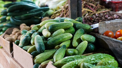 Fresh Cucumbers and Assorted Produce at a Vibrant Farmers Market