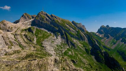 Stunning panoramic view of majestic mountains under clear blue sky in the alpine region during...