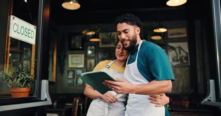 Waiter, team and talk with tablet at coffee shop, hug or happy with review, results or profit at front door. Man, woman and couple with embrace, tech or app for success, smile or partnership at diner - Powered by Adobe