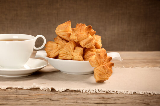in white bowol khari Snacks with tea cup