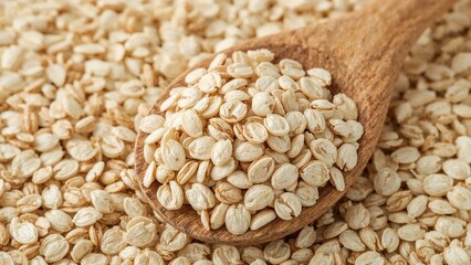 Fototapeta premium Wholesome organic rolled oats in wooden spoon