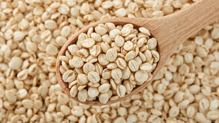 Fototapeta premium Wholesome rolled oats in a wooden spoon