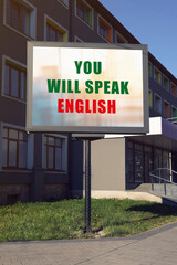 You Will Speak English text on advertising board in city. Language course