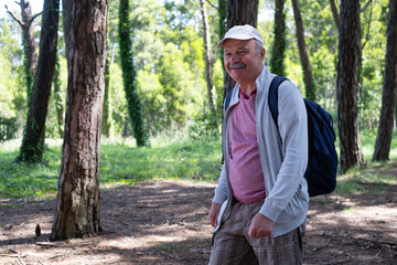 Elderly Man Walking Through the Forest During Vacation