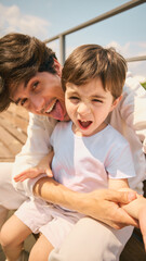 A father and son delight in a joyful interaction outside under the sunny sky, savoring time spent...